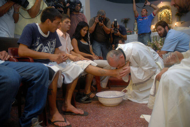 Argentine Cardinal Jorge Mario Bergoglio washes and kisses the feet of residents of a shelter for drug users during Holy Thursday Mass in 2008 at a church in a poor neighborhood of Buenos Aires, Argentina. The challenges and experiences of the church in Latin America figure heavily in Pope Francis' papacy, especially when it comes to making bishop appointments, addressing global issues and the pastoral care of the poor and the marginalized. (CNS photo/Enrique Garcia Medina, Reuters) See VATICAN-LETTER-LATIN