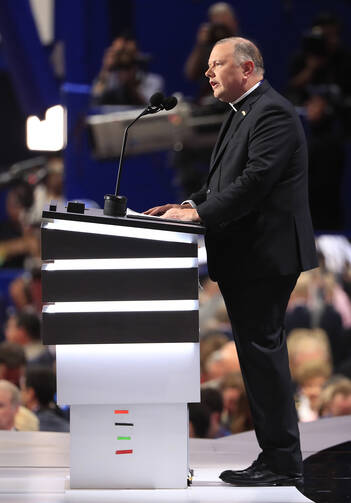 Msgr. Kieran Harrington, vicar of communications for the Diocese of Brooklyn, N.Y., delivers the invocation on July 18 during the first day of the 2016 Republican National Convention in Cleveland. (CNS photo/Tannen Maury, EPA)