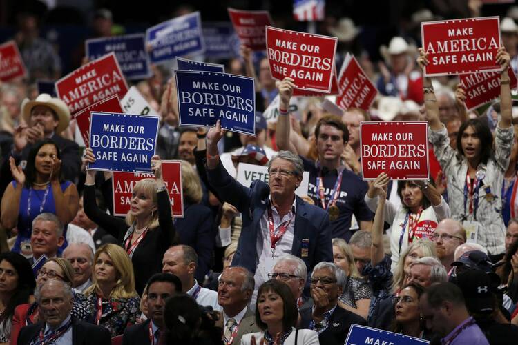 Delegates hold signs calling for border security, a facet of the extremely conservative 2016 platform, during the first day of the Republican National Convention in Cleveland on July 18. (CNS photo/Mario Anzuoni, Reuters)