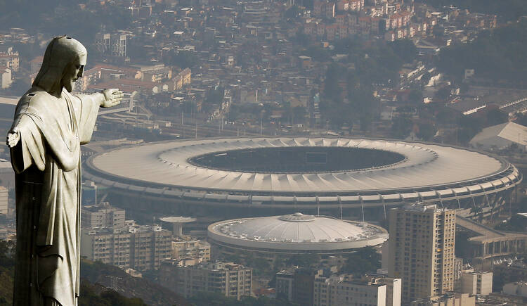 An aerial view of Rio de Janeiro on July 16 shows the Christ the Redeemer statue with Maracana stadium in the background. (CNS photo/Ricardo Moraes, Reuters)