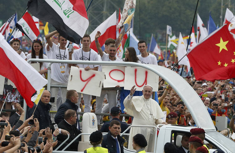 Pope Francis greets the crowd as he arrives to attend the World Youth Day welcoming ceremony in Blonia Park in Krakow, Poland, July 28. (CNS photo/Paul Haring)