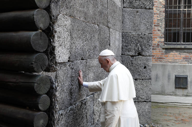 Pope Francis touches the death wall at the Auschwitz Nazi death camp in Oswiecim, Poland, July 29. (CNS photo/Paul Haring) 