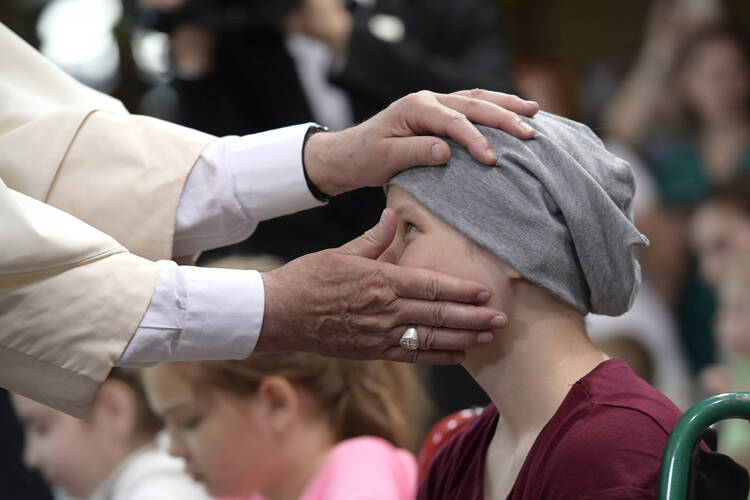  Pope Francis blesses a girl during a visit to the Children's University Hospital in Krakow, Poland, July 29. (CNS photo/L'Osservatore Romano via Reuters) 
