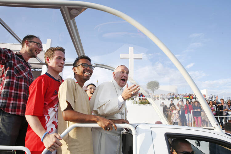 Pope Francis rides with pilgrims as part of World Youth Day in Krakow, Poland, on July 30. While in Krakow, he offered a prayer for protection from terrorism. (CNS photo/Paul Haring).