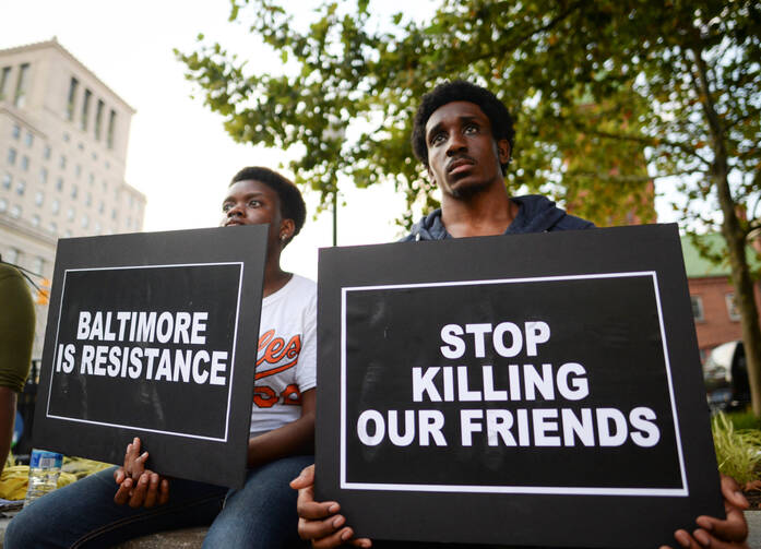 People gather to remember all victims of police violence during a rally outside City Hall in Baltimore July 27. (CNS photo/Bryan Woolston, Reuters) 