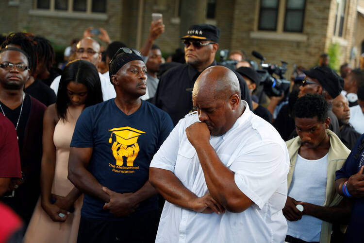 Community members attend a vigil Aug. 15 following the police shooting of a man in Milwaukee the previous day. (CNS photo/Aaron P. Bernstein, Reuters)