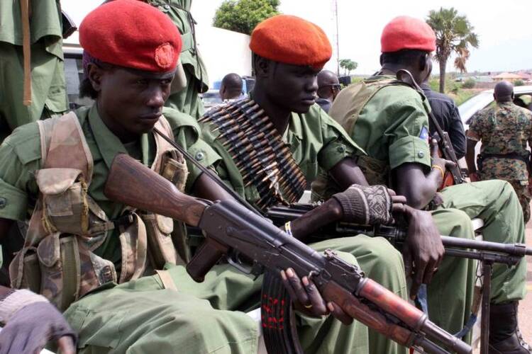 Soldiers with Gen. Simon Gatwech Dual, the chief of staff of the South Sudan rebel troops, arrive in late April in Juba. (CNS photo/Phillip Dhil, EPA)