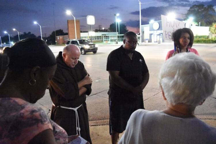 Parishioners from several Detroit parishes gather Aug. 25 to pray for peace, an effort organized by the Archdiocese of Detroit’s Office of Black Catholic Ministries. (CNS photo/Dan Meloy, Michigan Catholic) 