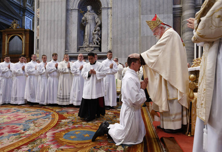 Cardinal Sean P. O'Malley of Boston ordains seminarian Mark Mleziva of the Diocese of Green Bay, Wis., as a transitional deacon during an ordination Mass in St. Peter's Basilica at the Vatican Sept. 29. (CNS photo/Paul Haring)