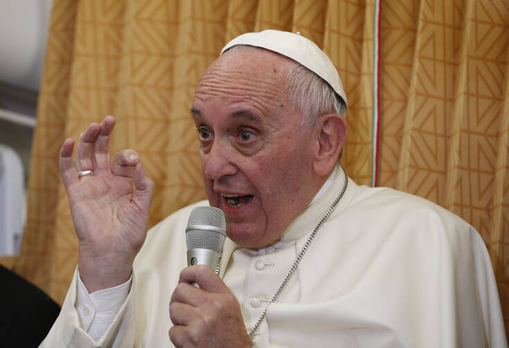 Pope Francis answers questions from journalists aboard his flight from Baku, Azerbaijan, to Rome Oct. 2. (CNS photo/Paul Haring)