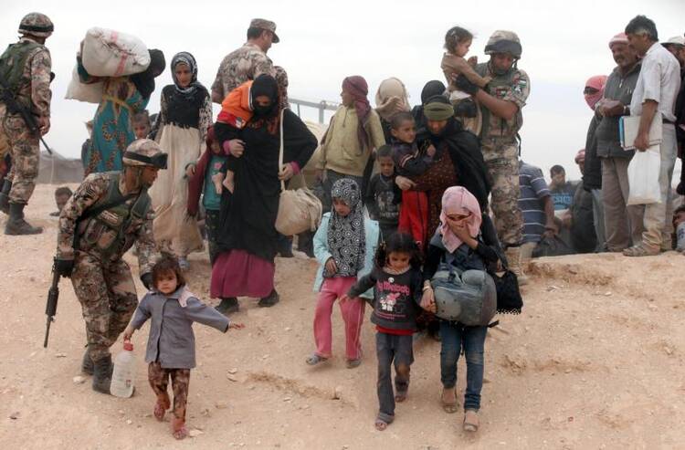 Syrian refugees arrive at a camp after crossing into the Jordanian side of the northeast Jordan-Syria border near Royashed. (CNS photo/Jamal Nasrallah, EPA)