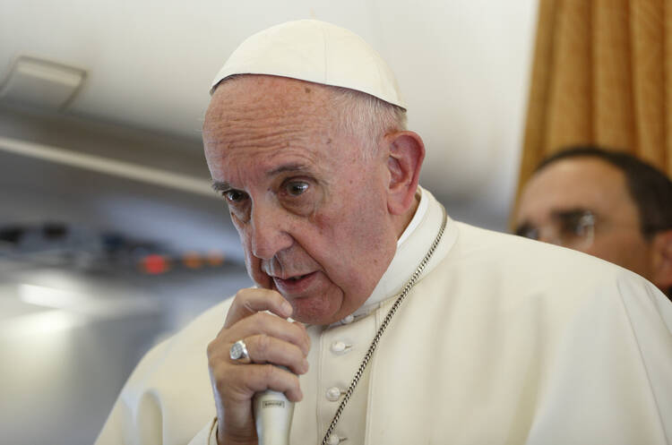 Pope Francis answers questions from journalists aboard his flight from Malmo, Sweden, to Rome Nov. 1. (CNS photo/Paul Haring)