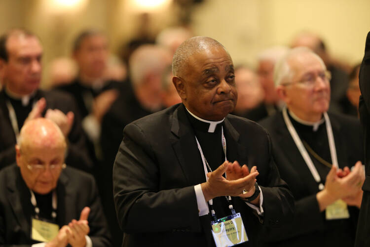 Atlanta Archbishop Wilton D. Gregory, center, and other prelates applaud on Nov. 14 after an address by Archbishop Christophe Pierre, apostolic nuncio to the United States, during the annual fall general assembly of the U.S. Conference of Catholic Bishops in Baltimore. (CNS photo/Bob Roller)