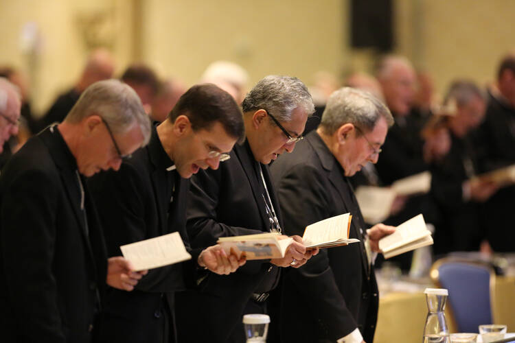 Bishops bow during morning prayer Nov. 15 at the annual fall general assembly of the U.S. Conference of Catholic Bishops in Baltimore. (CNS photo/Bob Roller)