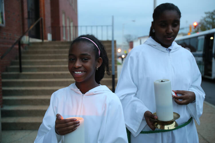 Altar servers stand outside St. Peter Claver Church in Baltimore before Mass Nov. 14. The U.S. bishops' traditional Mass for their annual fall general assembly was celebrated at the historic African-American church. (CNS photo/Bob Roller) 