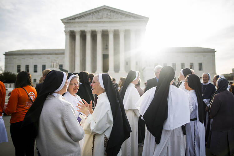 Women religious gather outside the U.S. Supreme Court in Washington on March 23, the day the high court heard oral arguments in religious groups' suit against the Affordable Care Act's contraceptive mandate. (CNS photo/Jim Lo Scalzo, EPA) 