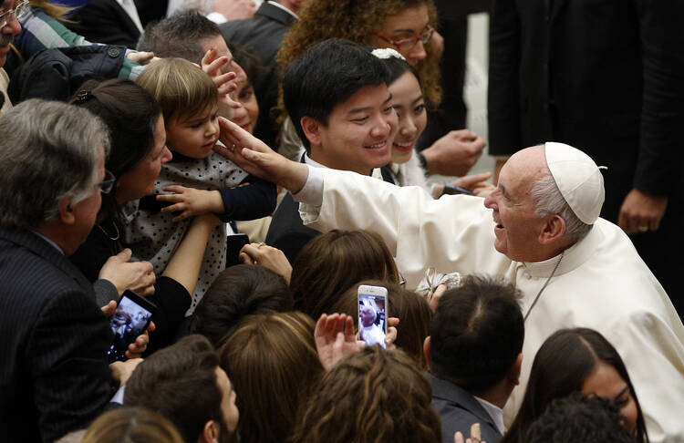 Pope Francis greets a child during his general audience in Paul VI hall at the Vatican Dec. 7. At his audience the pope began a new series of talks about hope. (CNS photo/Paul Haring) 