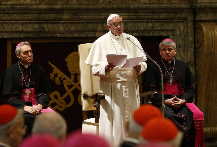 Pope Francis speaks during an audience to exchange Christmas greetings with members of the Roman Curia in Clementine Hall of the Apostolic Palace at the Vatican Dec. 22. (CNS photo/Paul Haring)