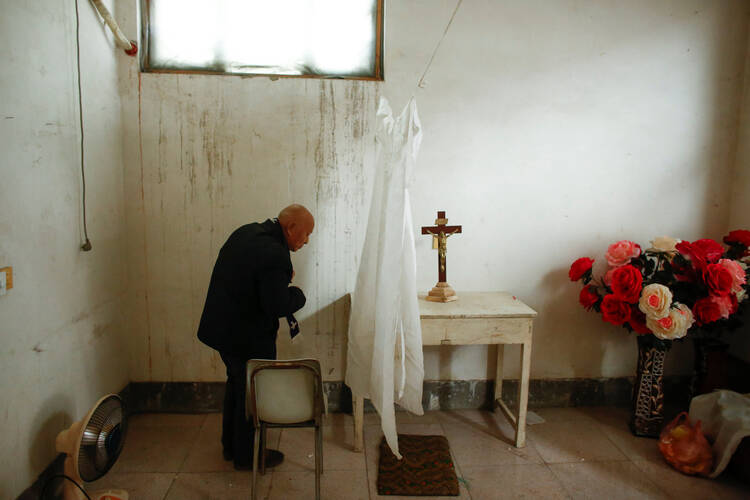 A retired bishop waits to hear confession at an unofficial Catholic church in Youtong village, Hebei Province, China. (CNS photo/Thomas Peter, Reuters)