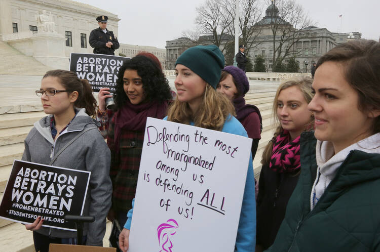 Mary Solitario, 21, center, a Catholic from Virginia, joins a pro-life demonstration outside the U.S. Supreme Court prior to the Women's March on Washington Jan. 21. (CNS photo/Bob Roller)