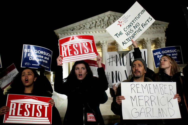 Protesters rally outside the Supreme Court in Washington on Jan. 31 against President Donald Trump's Supreme Court nominee Judge Neil Gorsuch. If confirmed, Gorsuch will fill the seat that has been empty since the death of Justice Antonin Scalia last February. (CNS photo/Yuri Gripas, Reuters) 