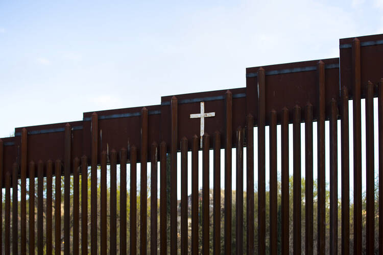 The bollard steel border fence splits the U.S. from Mexico in this view west of central Nogales, Ariz., Feb. 19. (CNS photo/Nancy Wiechec)