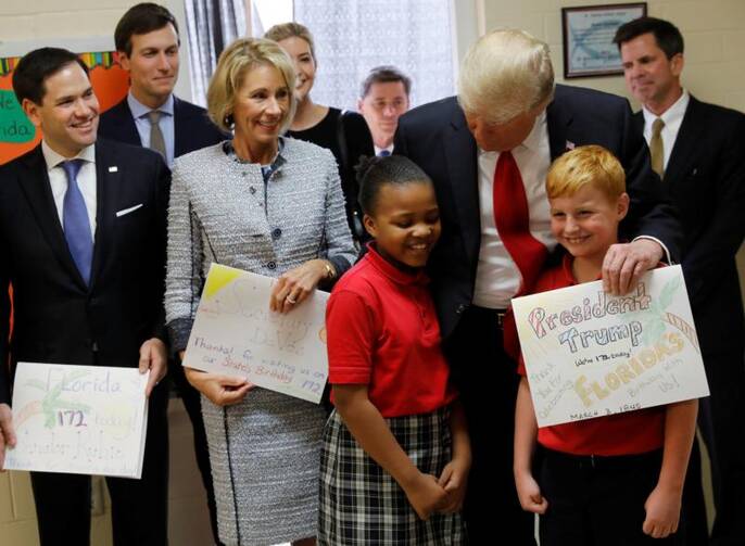 U.S. President Donald Trump chats with students from St. Andrew Catholic School in Orlando, Fla., on March 3. U.S. Sen. Marco Rubio, R-Fla., and U.S. Education Secretary Betsy DeVos also joined the president. (CNS photo/Jonathan Ernst, Reuters)