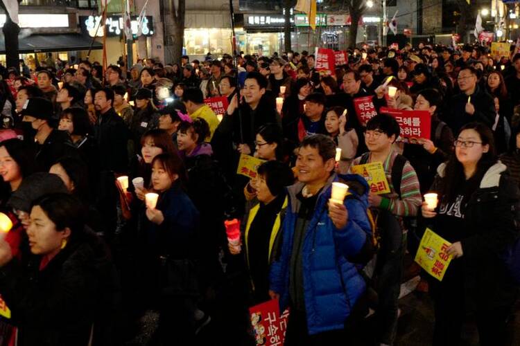 South Koreans gather to celebrate on March 11 after a court upheld the impeachment of South Korean President Park Geun-hye. Catholics in South Korea called for unity following the March 10 ruling. (CNS photo/Jeon Heon-Kyun, EPA)