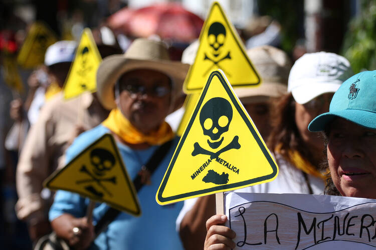 Protesters in El Salvador, demonstrate against mining exploitation March 9. El Salvador passed a law March 29 banning metal mining nationwide, after a long dispute between the government and a Canadian company involved in gold mining. (CNS photo/Oscar Rivera, EPA)