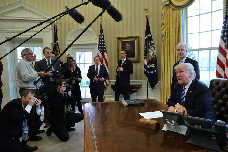 U.S. President Donald Trump talks to journalists in the Oval Office at the White House on March 24 after the American Health Care Act was pulled before a vote. (CNS photo/Carlos Barria, Reuters)