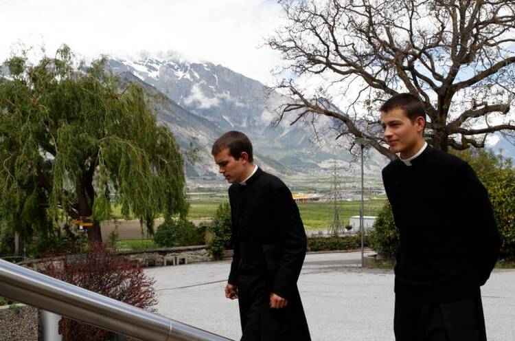 Seminarians walk on the grounds of the Society of St. Pius X seminary in Econe, Switzerland, in this May 9, 2012, file photo. (CNS photo/Paul Haring)