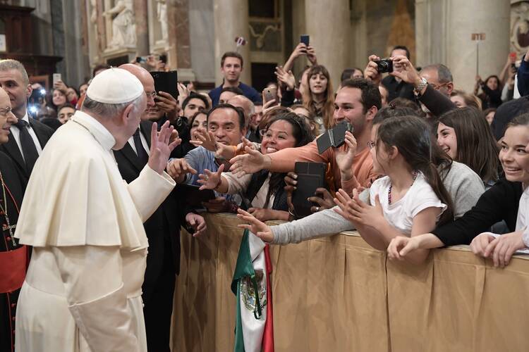 Pope Francis waves during an evening prayer vigil with young people at the Basilica of St. Mary Major in Rome on April 8. (CNS photo/L'Osservatore Romano)