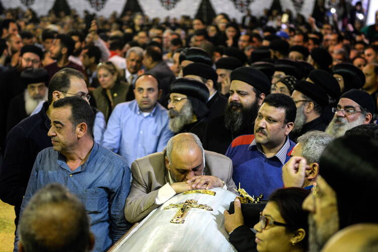Mourners attend the April 10 funeral for victims of a bomb attack the previous day at the Orthodox Church of St. George in Tanta, Egypt. (CNS photo/Mohamed Hossam, EPA)