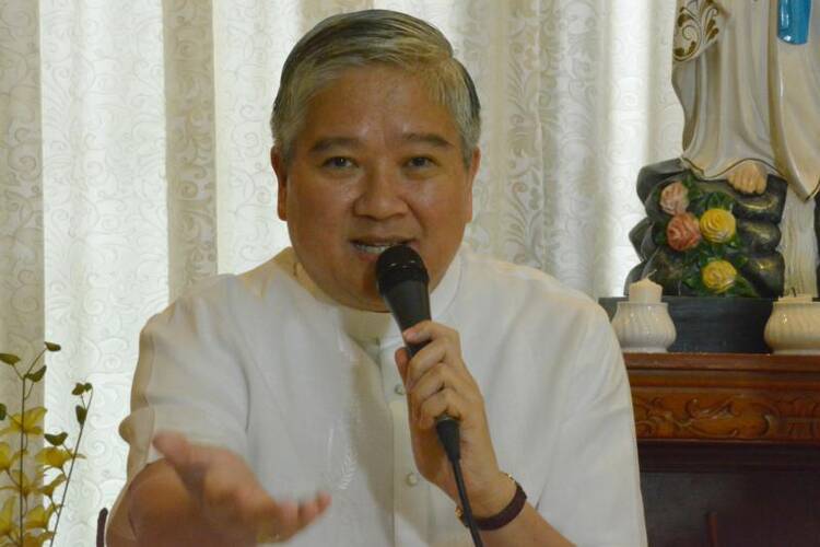 Archbishop Socrates Villegas, head of the Catholic Bishops' Conference of the Philippines, gestures during a 2014 news conference in Manila. (CNS photo/Simone Orendain) 