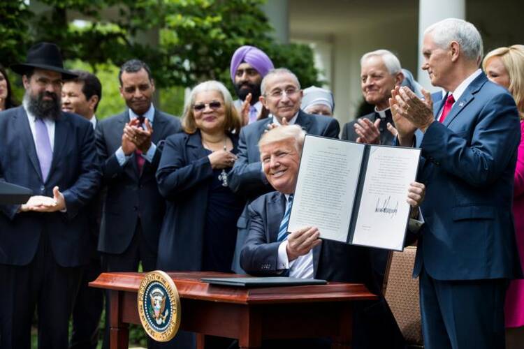 President Donald Trump shows his signed Executive Order on Promoting Free Speech and Religious Liberty during a National Day of Prayer event at the White House in Washington on May 4. (CNS photo/Jim Lo Scalzo, EPA) 