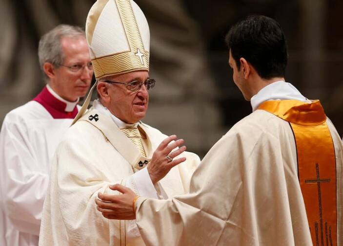 Pope Francis ordains one of 10 new priests for the Diocese of Rome during an ordination Mass in St. Peter's Basilica at the Vatican on May 7. (CNS photo/Paul Haring)