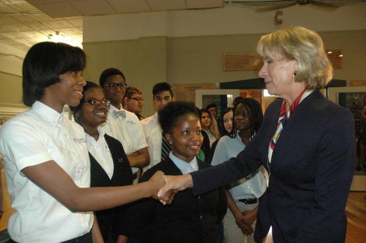 U.S. Secretary of Education Betsy DeVos shakes hands with Alexis Stratton, a freshman at Providence Cristo Rey High School in Indianapolis, during the secretary's May 23 visit to the school. (CNS photo/John Shaughnessy, The Criterion)