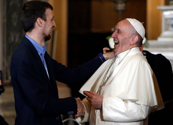 Pope Francis laughs as he speaks with a man in the Shrine of Our Lady of the Watch during his May 27 pastoral visit in Genoa, Italy. (CNS photo/Alessandro Garofalo, Reuters) 