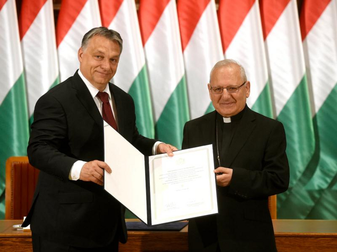 Image: Hungarian Prime Minister Viktor Orban and Chaldean Patriarch Louis Sako of Baghdad, Iraq, show the signed agreement on the Hungarian government's contribution of funds for restoring the houses of Iraqi. (CNS photo/Noemi Bruzak, EPA)