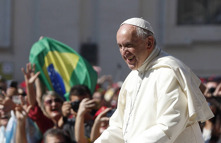 Pope Francis greets the crowd during his general audience in St. Peter's Square at the Vatican on May 31. (CNS photo/Paul Haring)