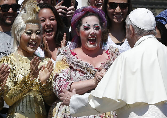 Pope Francis greets artists from Cirque du Soleil during his general audience in St. Peter's Square at the Vatican May 31. (CNS photo/Paul Haring)