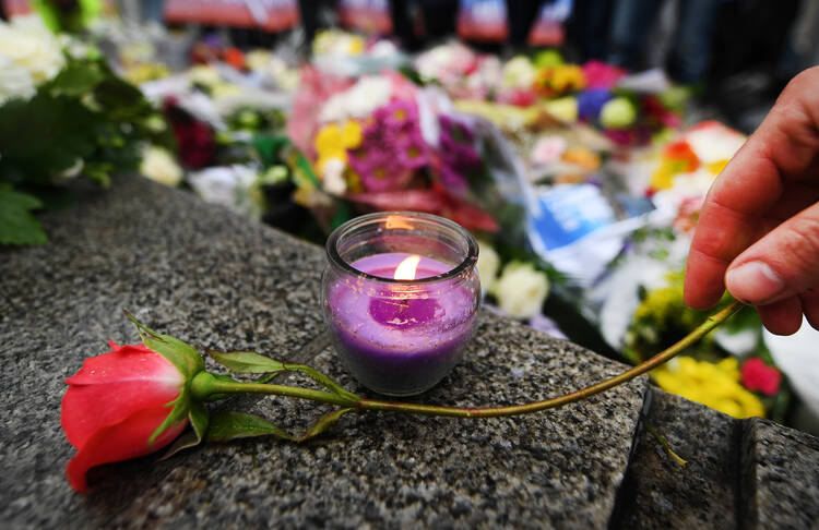 A floral tribute is seen during a vigil outside City Hall in London on June 5. (CNS photo/Andy Rain, EPA)