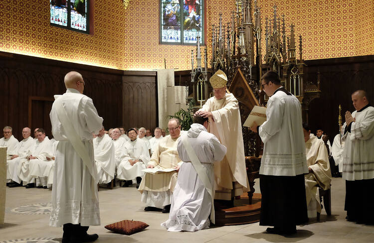 Bishop R. Walker Nickless of Sioux City, Iowa, lays hands on Deacon Andy Galles during his ordination into the priesthood on June 3 at the Cathedral of the Epiphany in Sioux City. (CNS photo/Jerry L Mennenga)