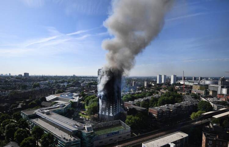Flames and smoke billow from a London apartment building on June 14. London's Metropolitan Police said a number of people were being treated for a range of injuries, and authorities appealed for families to report anyone unaccounted for. (CNS photo/Andy Rain, EPA) 