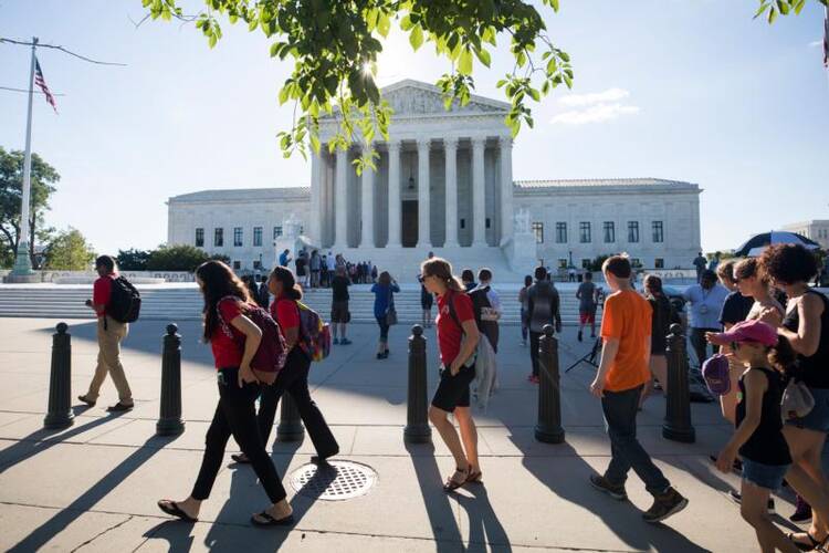 People gather outside the U.S. Supreme Court on June 26 in Washington. (CNS photo/Jim Lo Scalzo, EPA) 