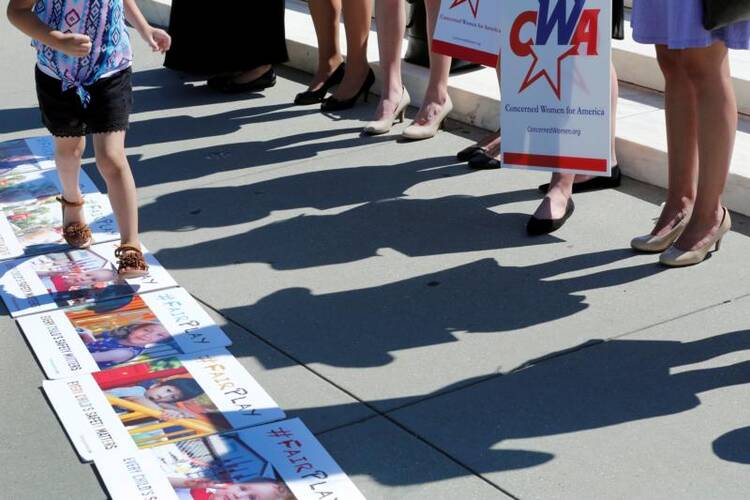 Activists rally outside U.S. Supreme Court in Washington on June 26 after the court sided with Trinity Lutheran Church in Columbia, Mo., which sued after being denied a state grant for creating a safer playground. (CNS photo/Yuri Gripas, Reuters)