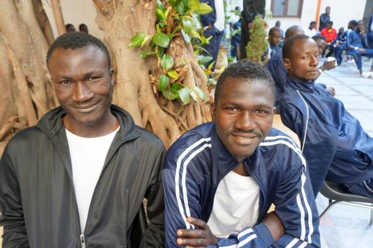 African migrants gather at the Caritas diocesan center in Palmero, Sicily, on June 1. (CNS photo/Dale Gavlak)