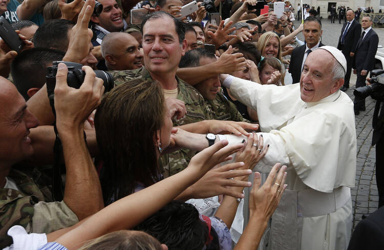 Pope Francis greets the crowd as he leaves his general audience in St. Peter's Square at the Vatican on June 28. (CNS photo/Paul Haring)