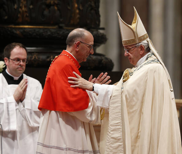 Pope Francis embraces Cardinal Juan Jose Omella of Barcelona, Spain, as the pontiff leads a consistory in St. Peter's Basilica at the Vatican June 28. The Spaniard was one of five men elevated to cardinal at the service. (CNS photo/Paul Haring) 