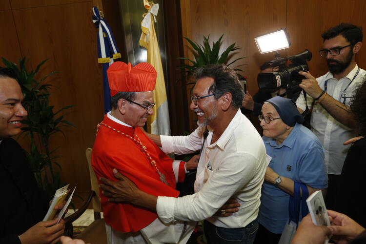 Cardinal Gregorio Rosa Chavez of San Salvador, El Salvador, is greeted after Pope Francis elevated him and four other men to cardinal during a June 28 consistory in St. Peter's Basilica at the Vatican. (CNS photo/Paul Haring)